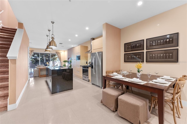 kitchen with pendant lighting, stainless steel appliances, and light tile patterned floors