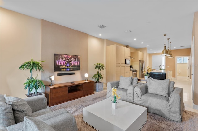 carpeted living room featuring sink