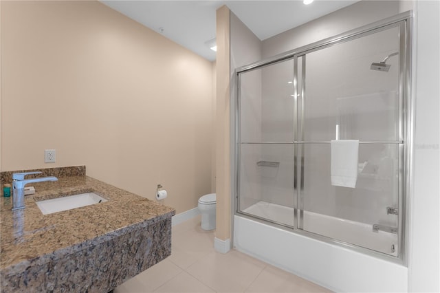 full bathroom featuring tile patterned flooring, toilet, shower / bath combination with glass door, and sink