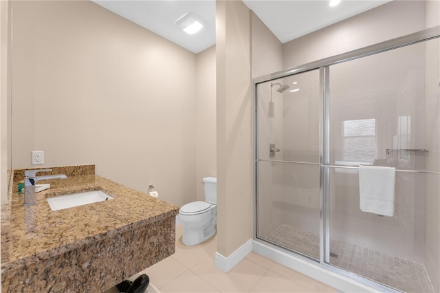 bathroom with sink, tile patterned flooring, toilet, and a shower with door