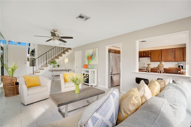 tiled living room featuring sink and ceiling fan