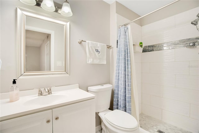 bathroom with walk in shower, vanity, and toilet