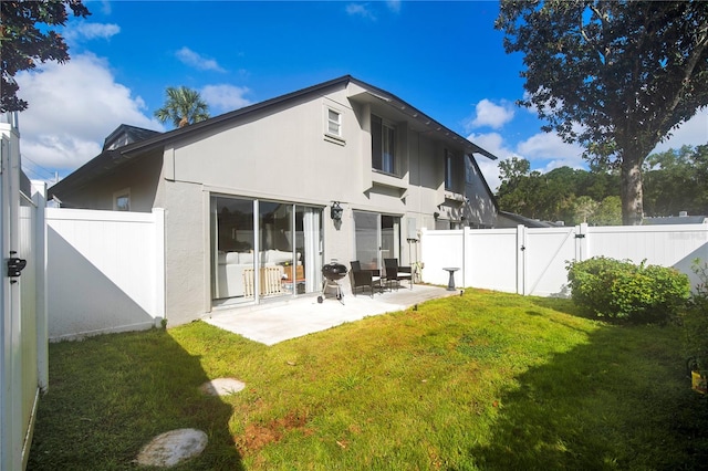 back of property featuring a lawn and a patio