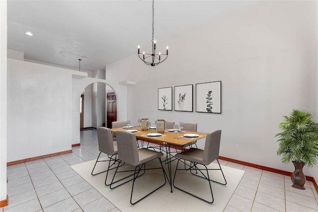 tiled dining room with an inviting chandelier