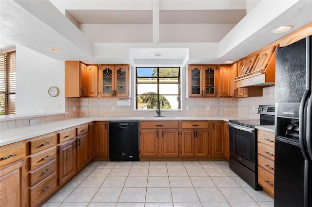 kitchen featuring light tile patterned flooring, black appliances, sink, and tasteful backsplash