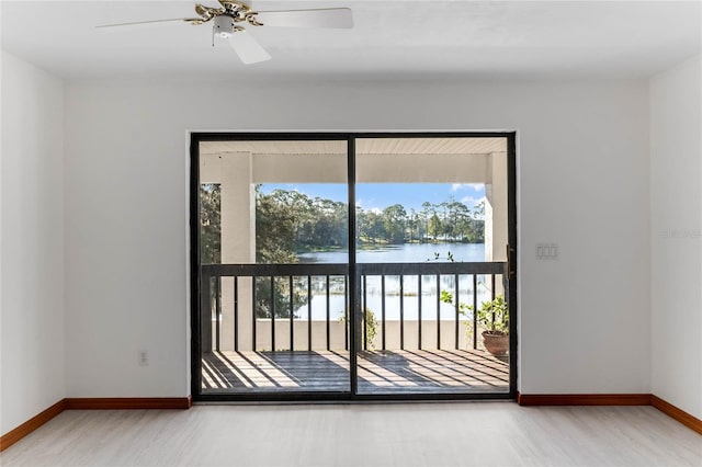 entryway featuring hardwood / wood-style floors, a water view, and ceiling fan