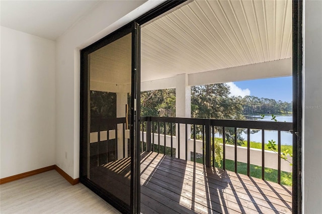 wooden deck featuring a water view