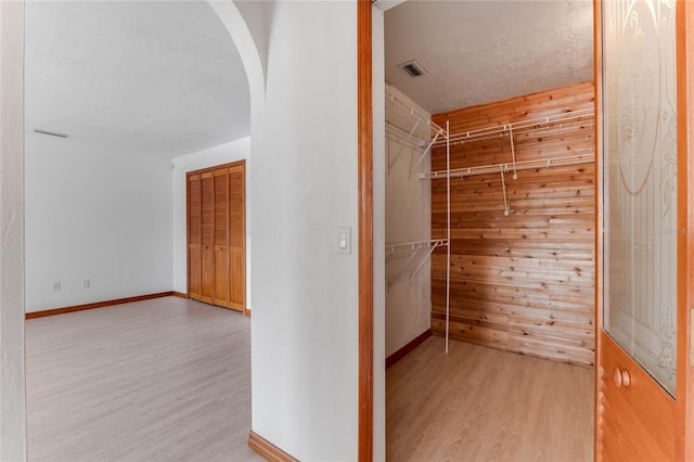 walk in closet featuring light hardwood / wood-style flooring