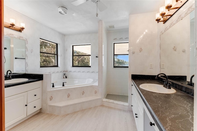 bathroom with vanity, plus walk in shower, and ceiling fan