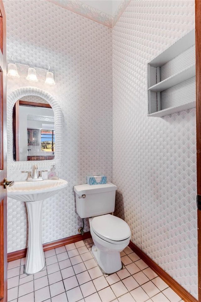 bathroom with toilet and tile patterned floors