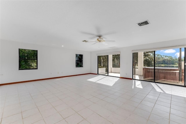 empty room featuring light tile patterned floors and ceiling fan