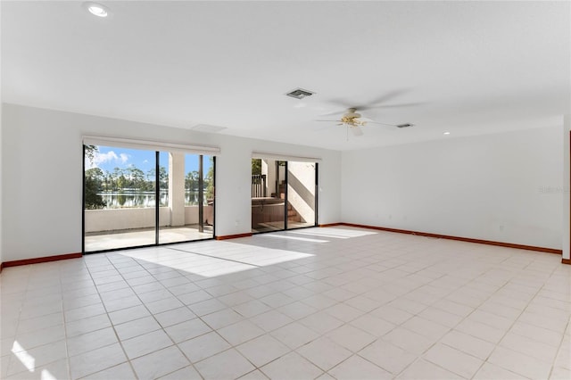 tiled empty room featuring ceiling fan