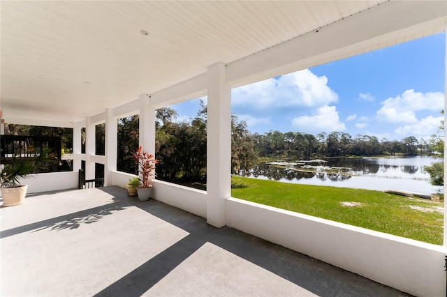 unfurnished sunroom with a water view