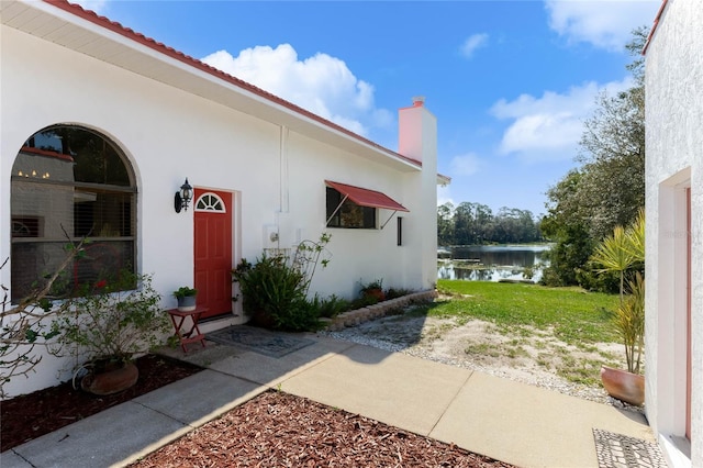 doorway to property with a water view