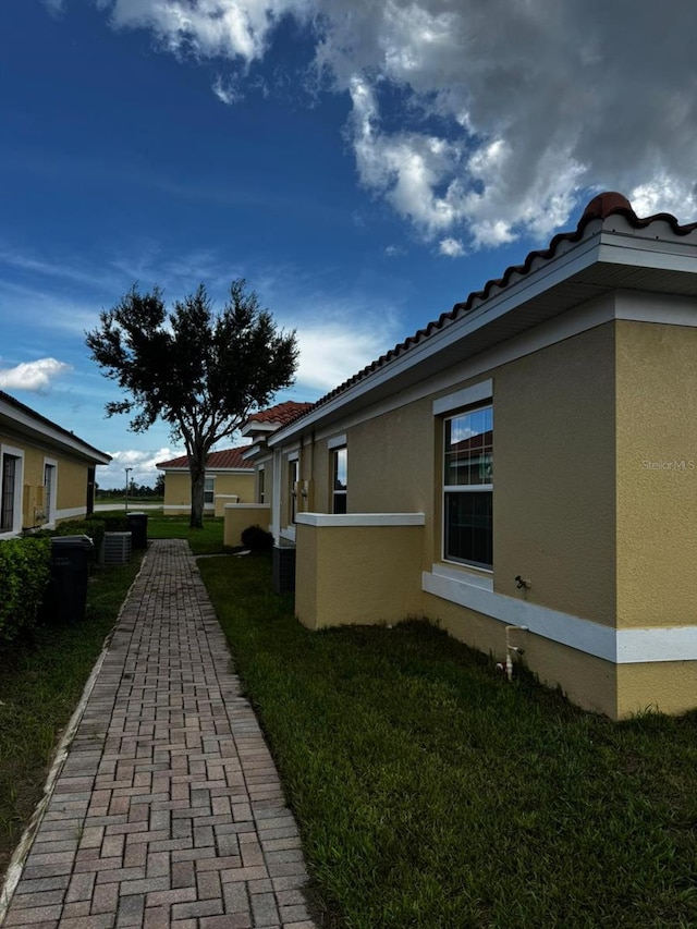 view of property exterior featuring a lawn