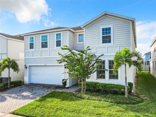 view of front of home with a front lawn and a garage