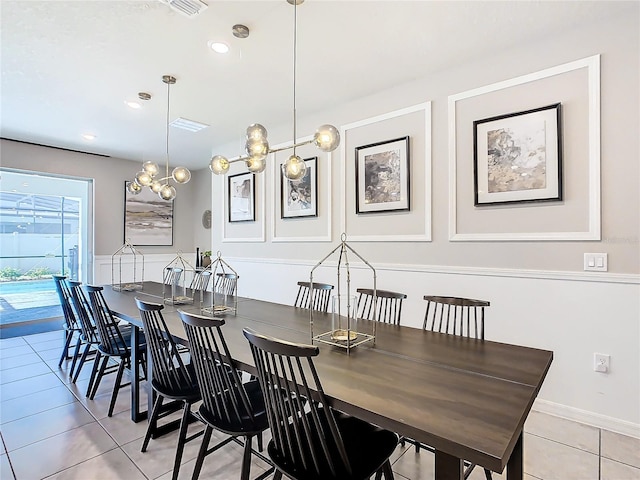 tiled dining area featuring a notable chandelier