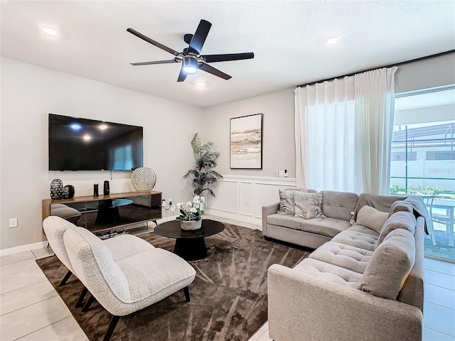 living room with tile patterned flooring and ceiling fan