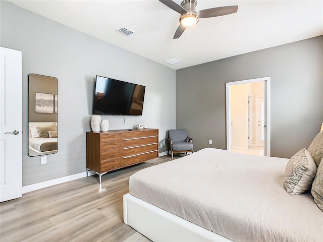 bedroom featuring ceiling fan, ensuite bathroom, and hardwood / wood-style floors