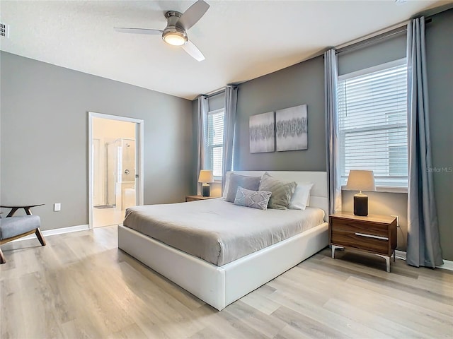 bedroom with ceiling fan, connected bathroom, and hardwood / wood-style floors