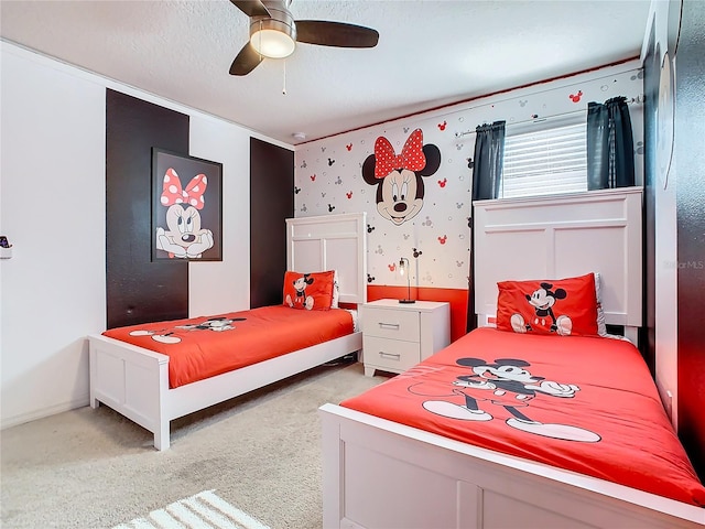 bedroom with ceiling fan, a textured ceiling, and light carpet