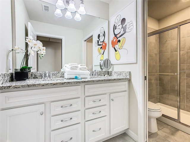 bathroom featuring tile patterned flooring, walk in shower, vanity, and toilet