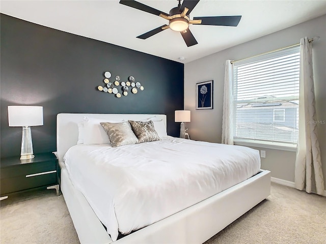 bedroom with ceiling fan and light colored carpet