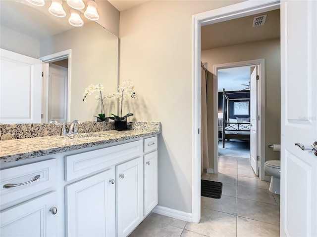 bathroom featuring vanity, toilet, and tile patterned floors