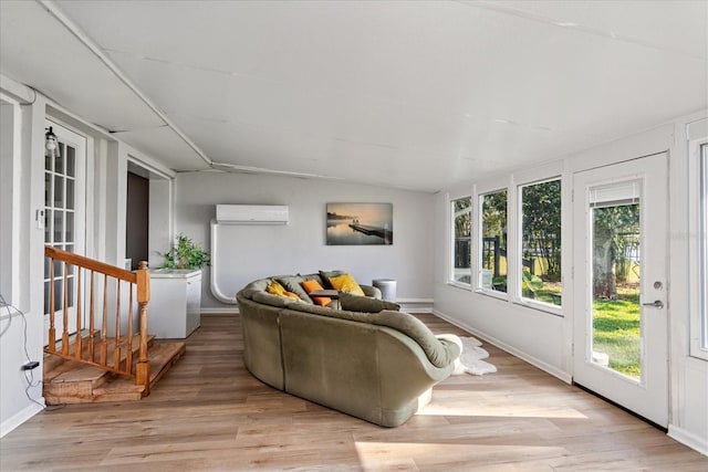 sunroom featuring lofted ceiling and a wall unit AC