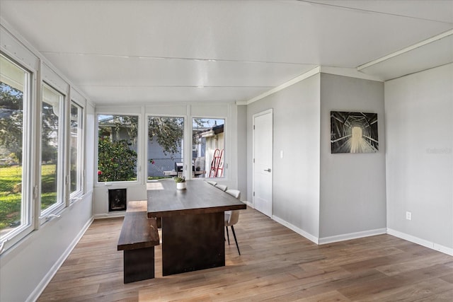 sunroom with vaulted ceiling and a healthy amount of sunlight