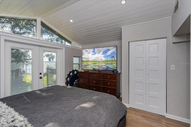 bedroom featuring light hardwood / wood-style floors, vaulted ceiling, a closet, wooden ceiling, and access to outside