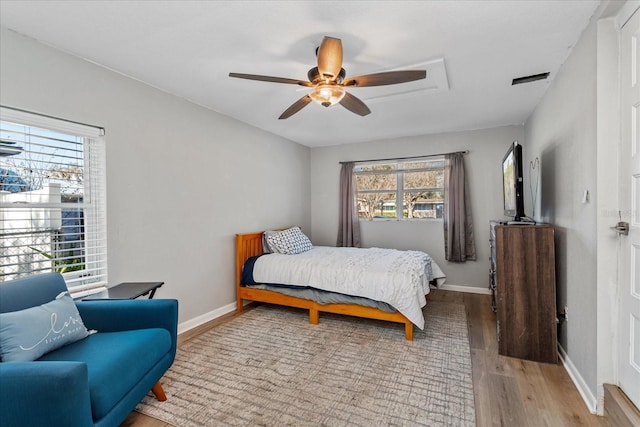 bedroom with ceiling fan and light wood-type flooring