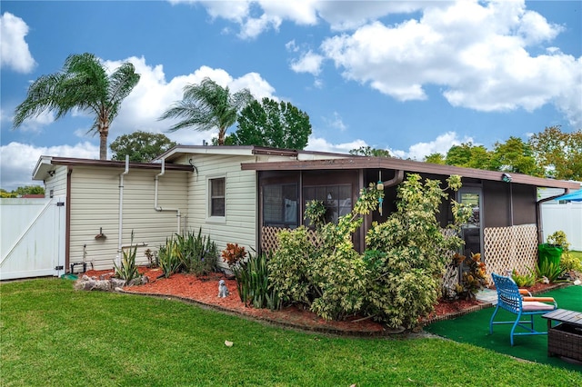 rear view of property with a yard