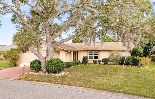 view of front facade with a garage and a front yard