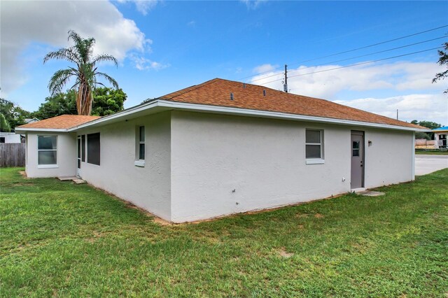 rear view of property with a lawn