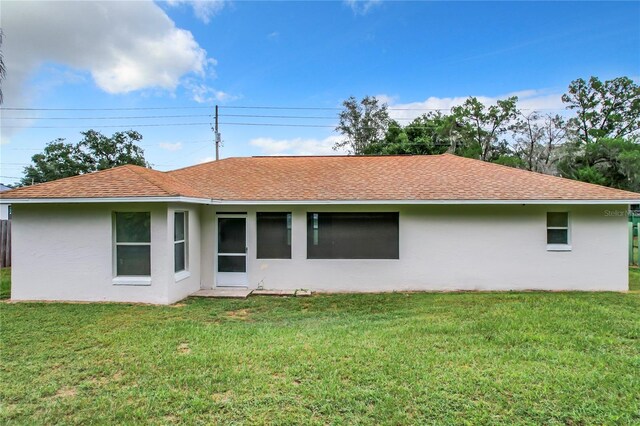 rear view of house with a yard