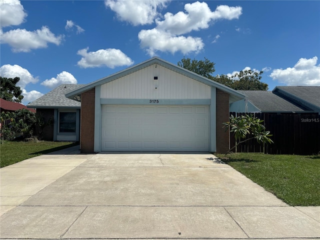 ranch-style house with a garage and a front yard