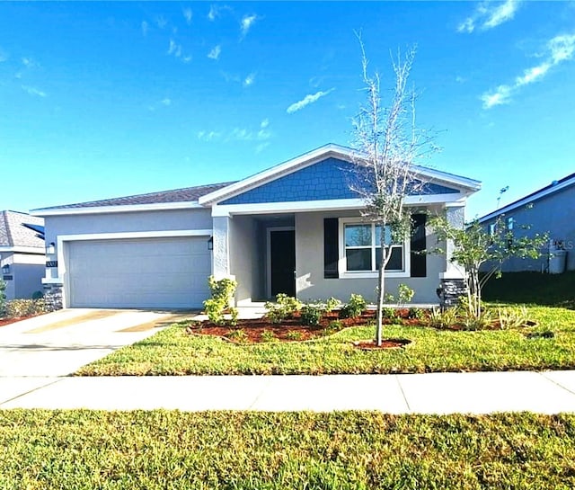 view of front of house with a garage and a front lawn