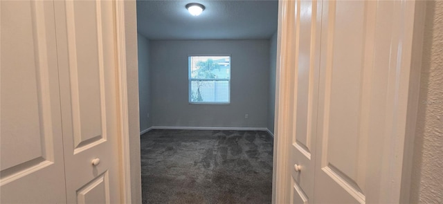 carpeted empty room with a textured ceiling