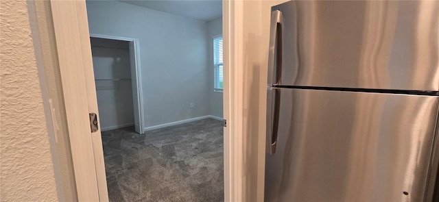 kitchen featuring stainless steel refrigerator and dark colored carpet