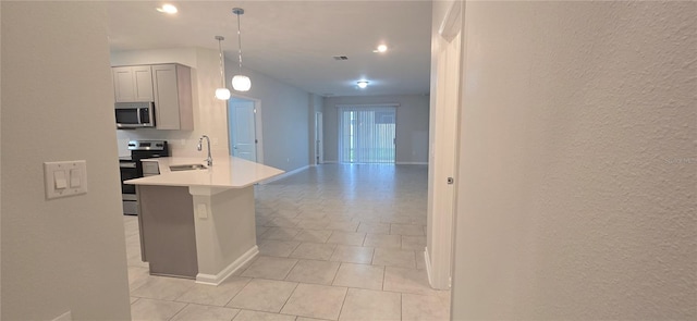 kitchen with pendant lighting, light tile patterned floors, sink, gray cabinetry, and appliances with stainless steel finishes