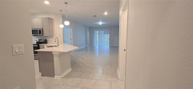 1007 Theodore St, Davenport, FL 33837 - kitchen featuring a peninsula, a sink, visible vents, light countertops, and appliances with stainless steel finishes