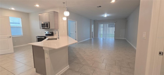 1007 Theodore St, Davenport, FL 33837 - kitchen with light countertops, visible vents, a sink, baseboards, and appliances with stainless steel finishes