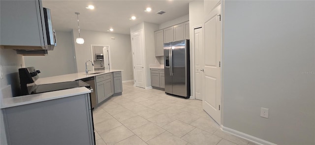 kitchen with light tile patterned flooring, sink, decorative light fixtures, gray cabinets, and stainless steel appliances