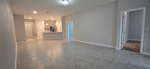 unfurnished living room featuring light tile patterned floors