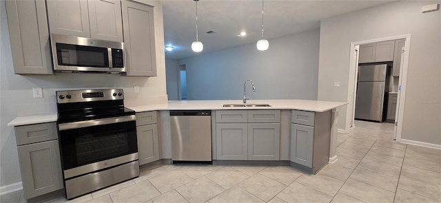 kitchen featuring appliances with stainless steel finishes, sink, kitchen peninsula, and gray cabinetry