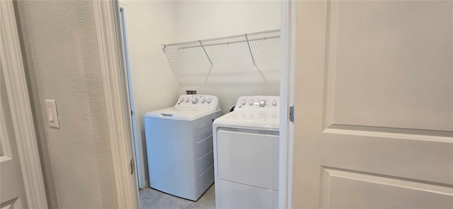 1007 Theodore St, Davenport, FL 33837 - laundry room with light tile patterned flooring, laundry area, and separate washer and dryer