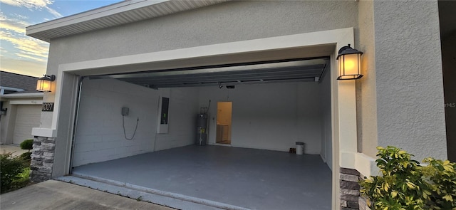 garage featuring water heater and electric panel