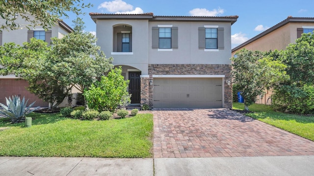 mediterranean / spanish house featuring a front yard and a garage