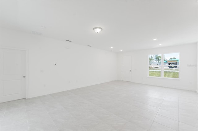 spare room featuring light tile patterned flooring